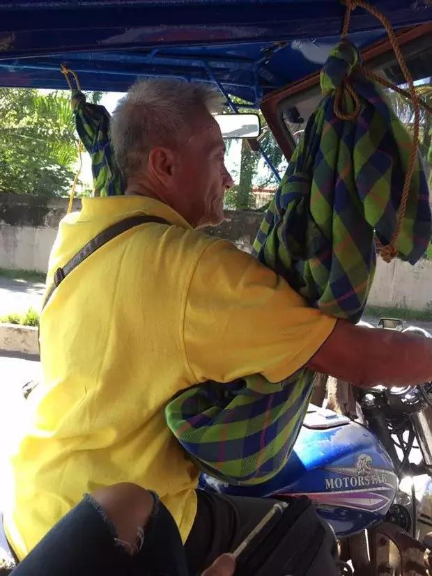 Photos of a Father Cradling His Son While Working as a Tricycle Driver