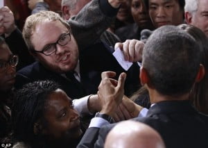 Occupy protester hands President Obama a note