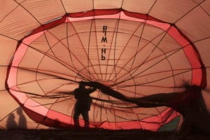 a worker fixes a balloon before it is flown