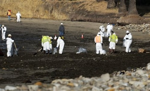 Clean up crews remove oil-laden sand on the beach at Refugio State Beach, site of an oil spill, north of Goleta, Calif., Wednesday, May 20, 2015. A broken onshore pipeline spewed oil down a storm drain and into the ocean for several hours Tuesday before it was shut off, creating a slick some 4 miles long about 20 miles west of Santa Barbara. (AP Photo/Michael A. Mariant)