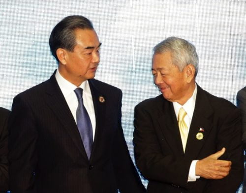 Chinese Foreign Minister Wang Yi,left , talks to Philippine Foreign Minister Perfecto Yassay after they pose for a photo during the Association of Southeast Asian Nations (ASEAN) Foreign Ministers' Meeting in Vientiane, Laos, Tuesday, July 26, 2016. (AP Photo/Sakchai Lalit)