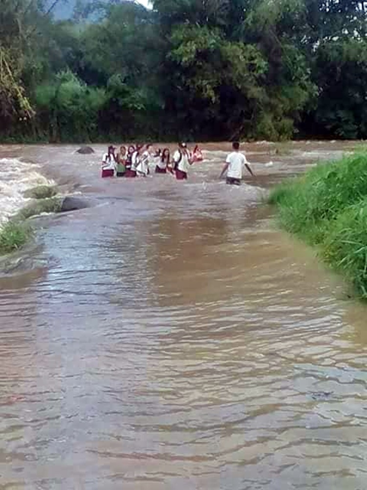 Negros Occidental students cross overflowing river