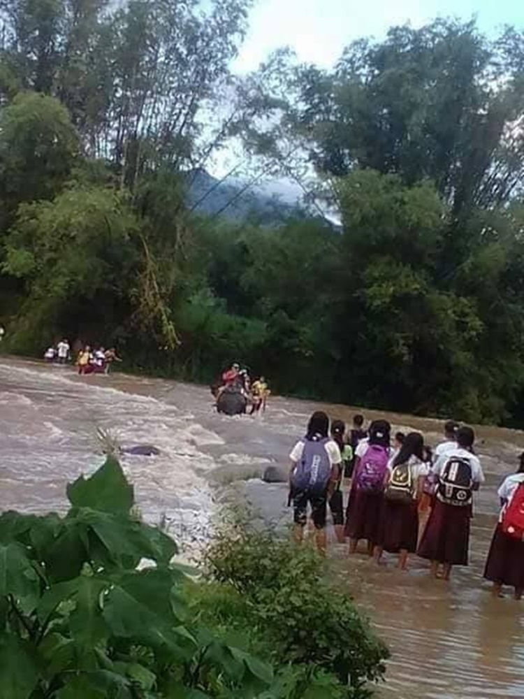 Negros Occidental students cross overflowing river