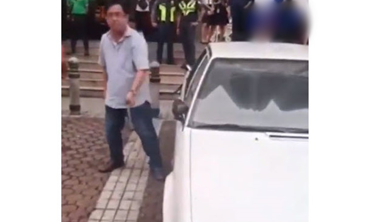 QC-Official-breaks-window