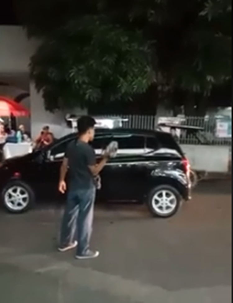 Drunk Man Runs Amok & Throws Huge Rock to Passing Vehicle (Video)