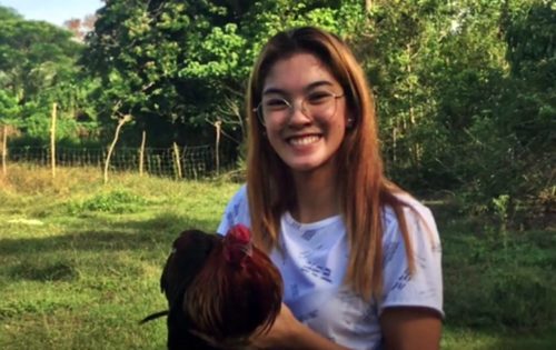young lady gives away chicken