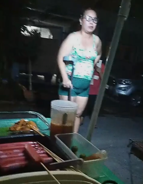 Woman Scolding Barbeque Vendor