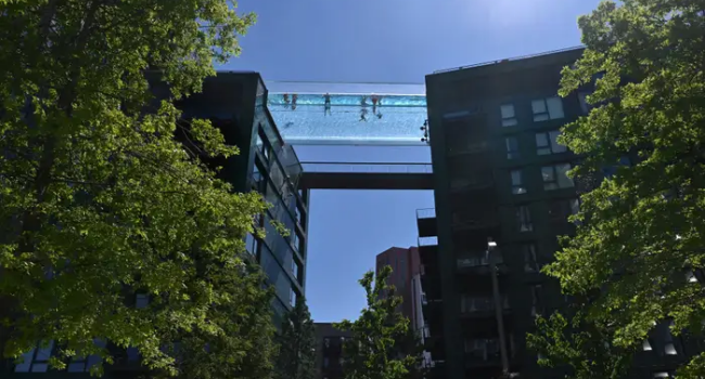 First Floating Transparent Pool Located Between Two Skyscrapers Opens