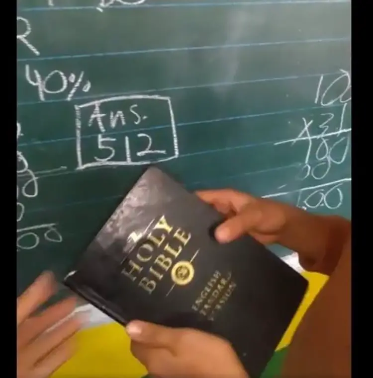 The teacher is praised for encouraging students to read the Bible during class